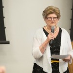 A woman addresses the audience